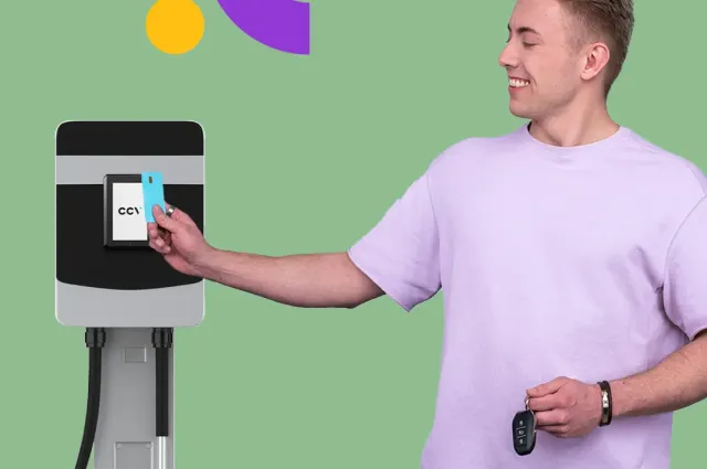 A young man paying at an EV charging station